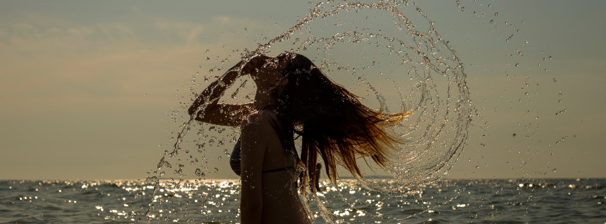 Ragazza in mare che muove i capelli
